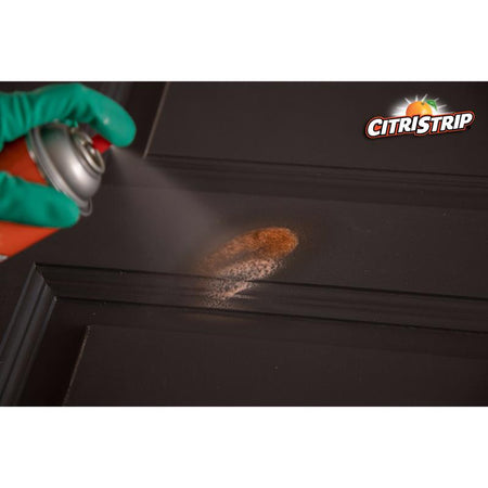 Klean Strip CitriStrip 17 Oz Paint & Varnish Stripper being sprayed on a door.