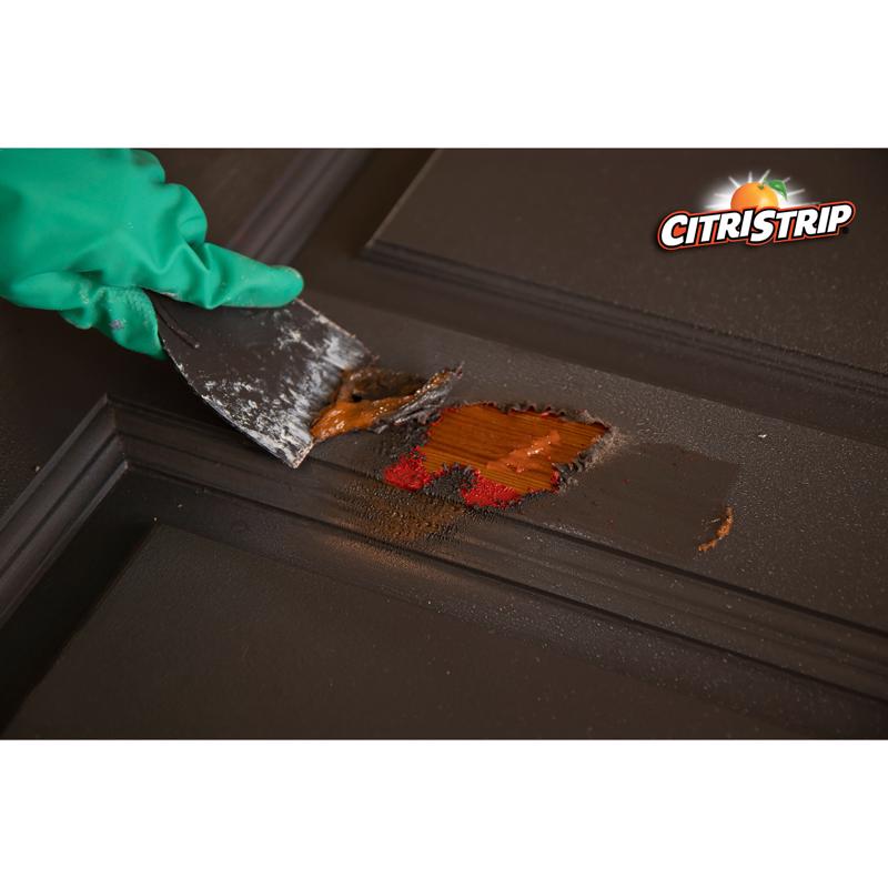 Klean Strip CitriStrip 17 Oz Paint & Varnish Stripper removing paint from a door with a scraper.