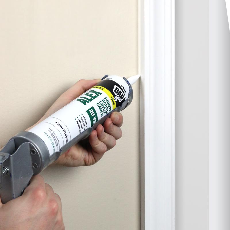 DAP 10.3 Oz Alex Painters Acrylic Latex Caulk being applied to gap on door tirm.