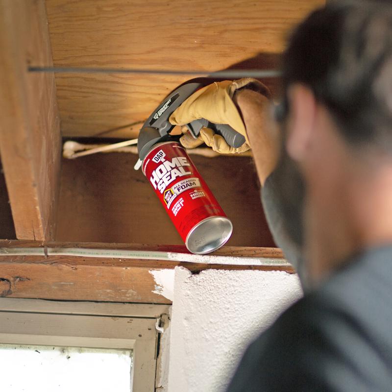 DAP Touch 'n Foam HomeSeal Minimum Expanding Sealant being applied to a gap in a ceiling joist.
