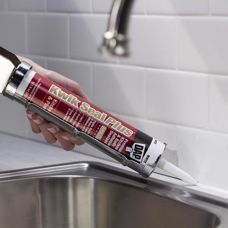 DAP Kwik Seal Plus Kitchen & Bath Caulk being applied around backsplash at kitchen sink.