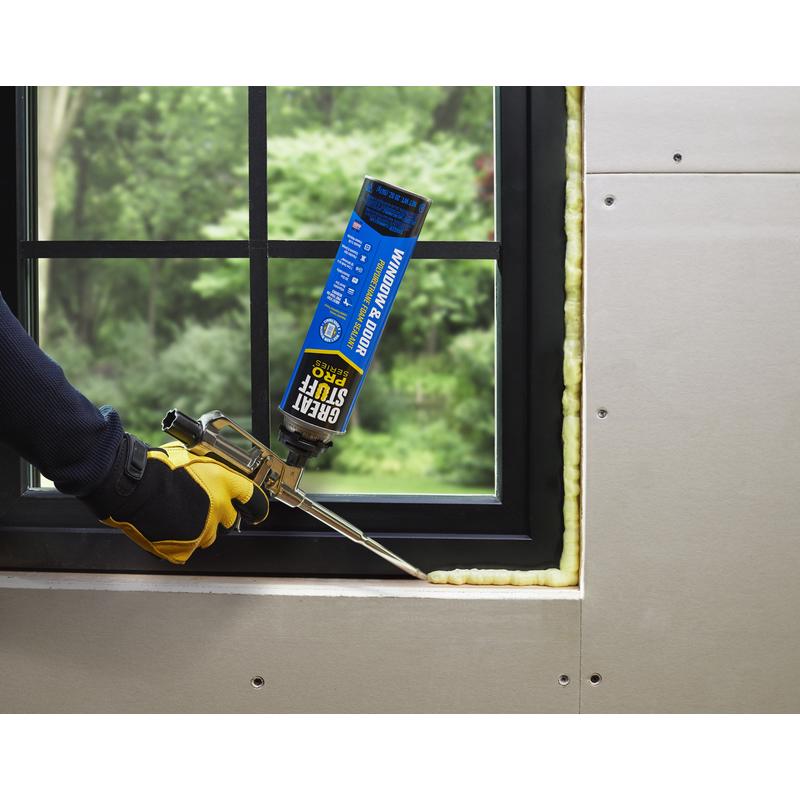 Great Stuff Pro Series Yellow Polyurethane Insulating Foam Sealant being applied around window.