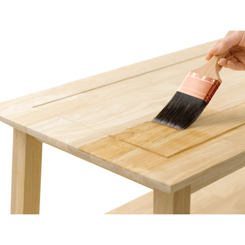 Minwax Water Based Pre-Stain Wood Conditioner being applied to the top of a table with a brush.