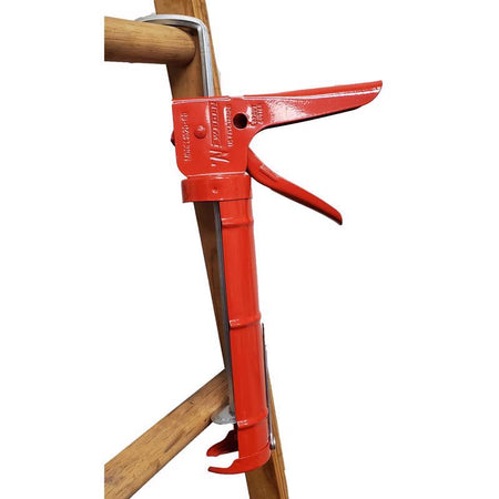 Newborn Professional Steel Drip Free Caulking Gun shown hanging from a ladder.