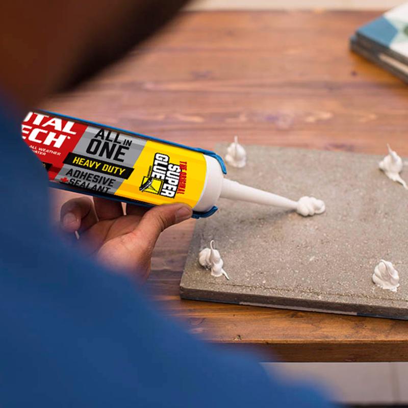 The Original Super Glue Total Tech Construction Adhesive Sealant being applied to the back of a square tile.
