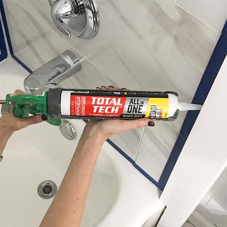 The Original Super Glue Total Tech Construction Adhesive Sealant 9.8 Oz being applied around a tub.