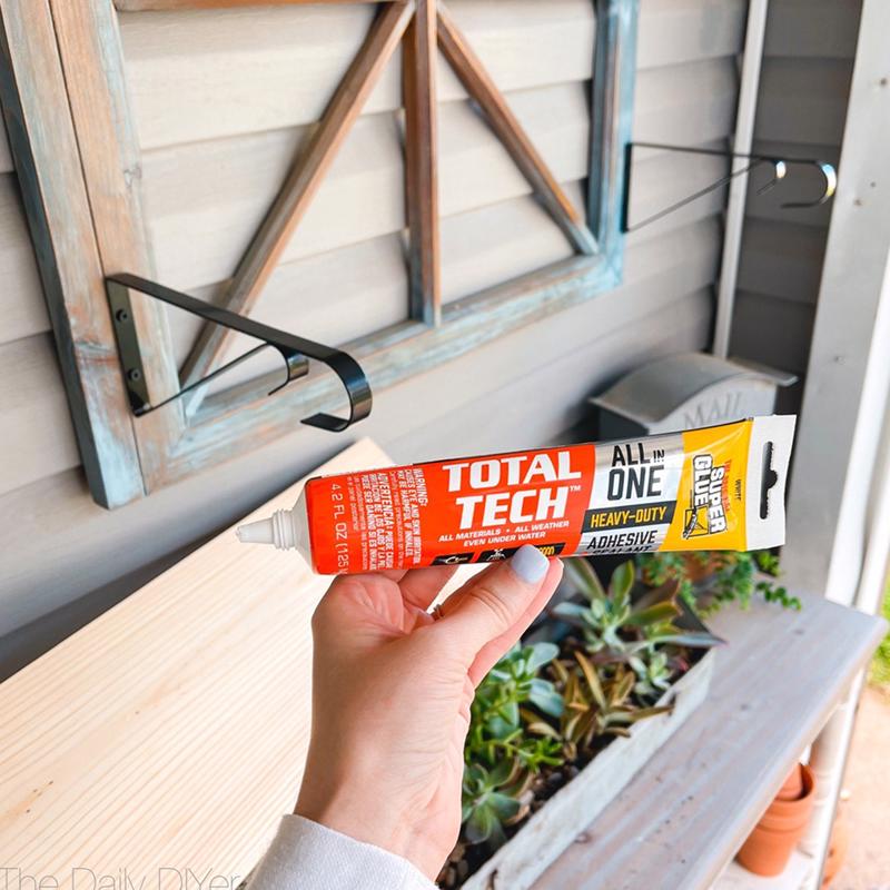The Original Super Glue Total Tech Construction Adhesive Sealant 4.2 Oz being applied to a piece of wood.