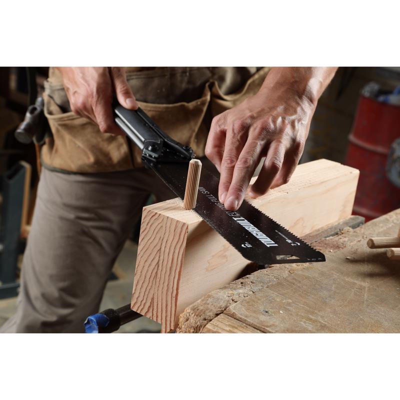 ToughBuilt Folding Pull Saw being used to saw a wooden dowel.