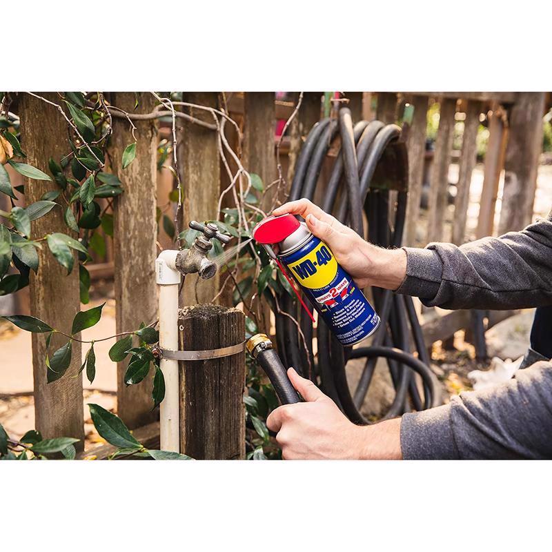 WD-40 Smart Straw Spray Lubricant being applied to a outdoor hose connector.