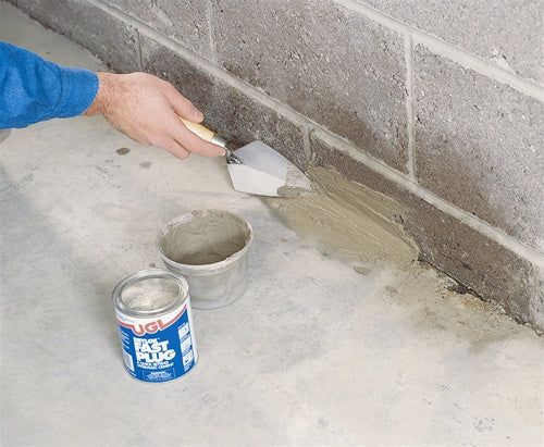 UGL Drylok Fast Plug Hydraulic Cement being applied on a basement ball.