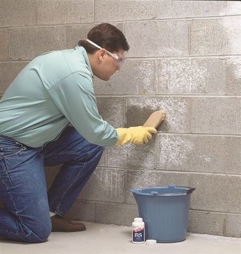 Man scrubbing a block wall with UGL Drylok Etch 01908.