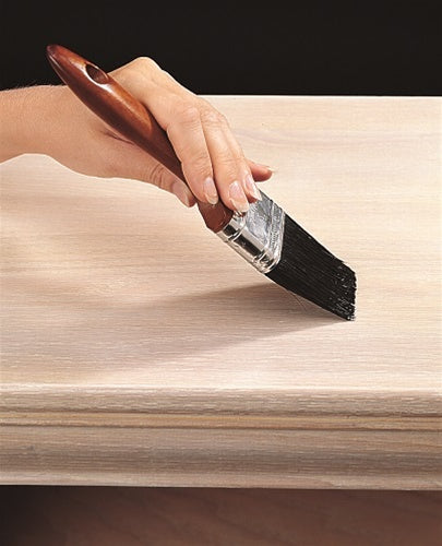 UGL Aqua ZAR® Water-Based Polyurethane being applied to a table with a paint brush.