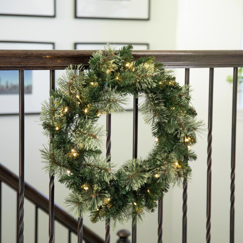 Decorative Christmas wreath with lights on a railing