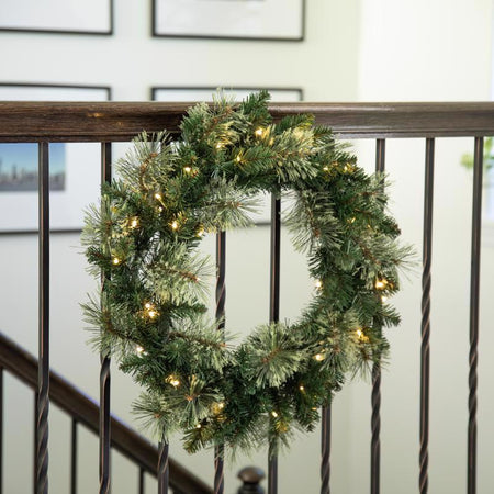 Decorative Christmas wreath with lights on a railing