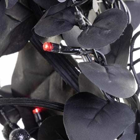 Close-up of Celebrations 9 ft. LED Lighted Halloween Skull Garland 09-03017A on a white background