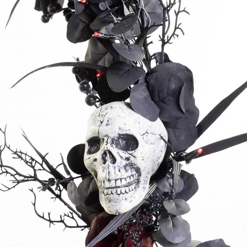 Decorative arrangement with skull, flowers, and branches on a white background