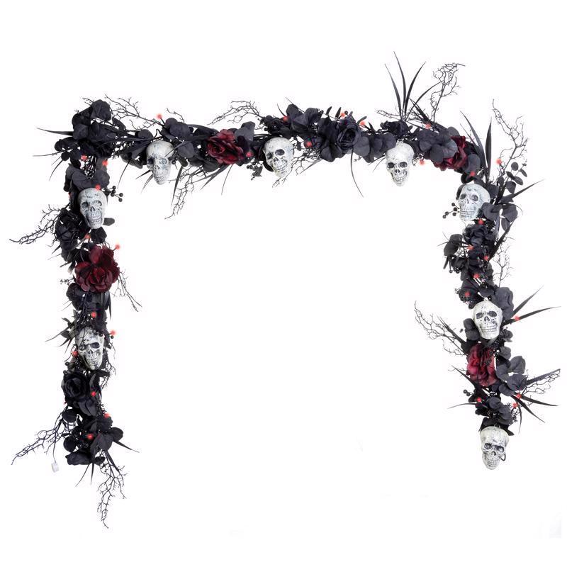 Decorative garland with skulls, flowers, and branches on a white background