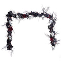 Decorative garland with skulls, flowers, and branches on a white background
