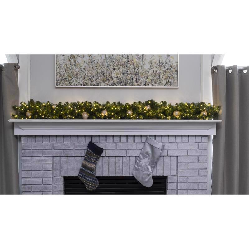 White brick fireplace with Christmas stockings and garland on a white background