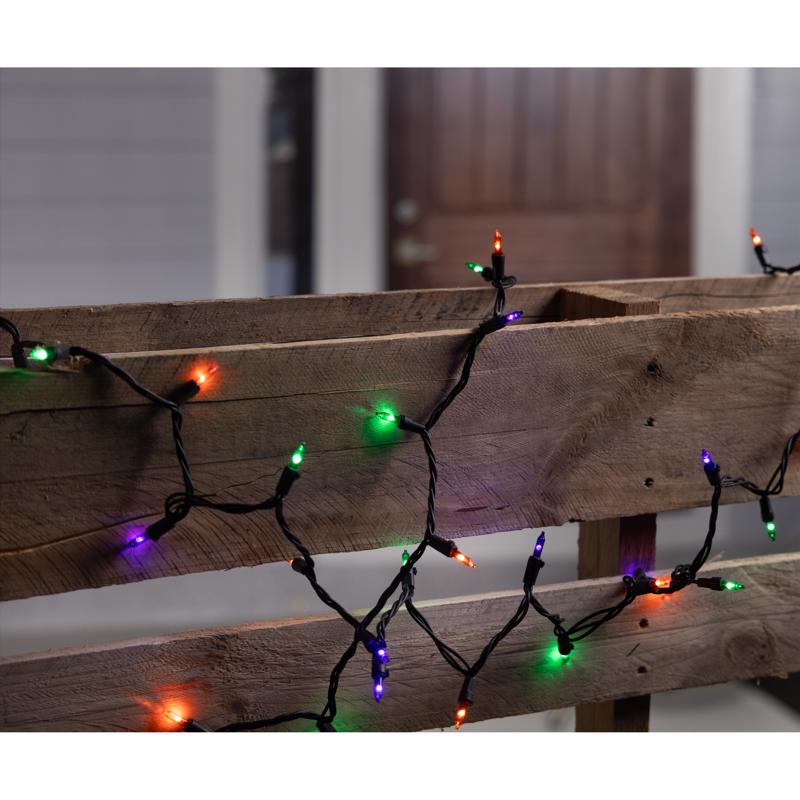 Halloween string lights on a wooden surface with a blurred background