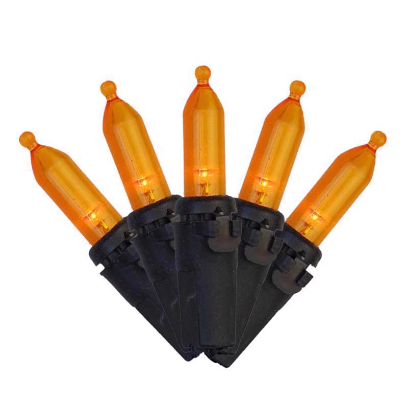 Set of orange Halloween lights with black holder on a white background