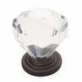 Clear crystal knob with bronze base on a white background