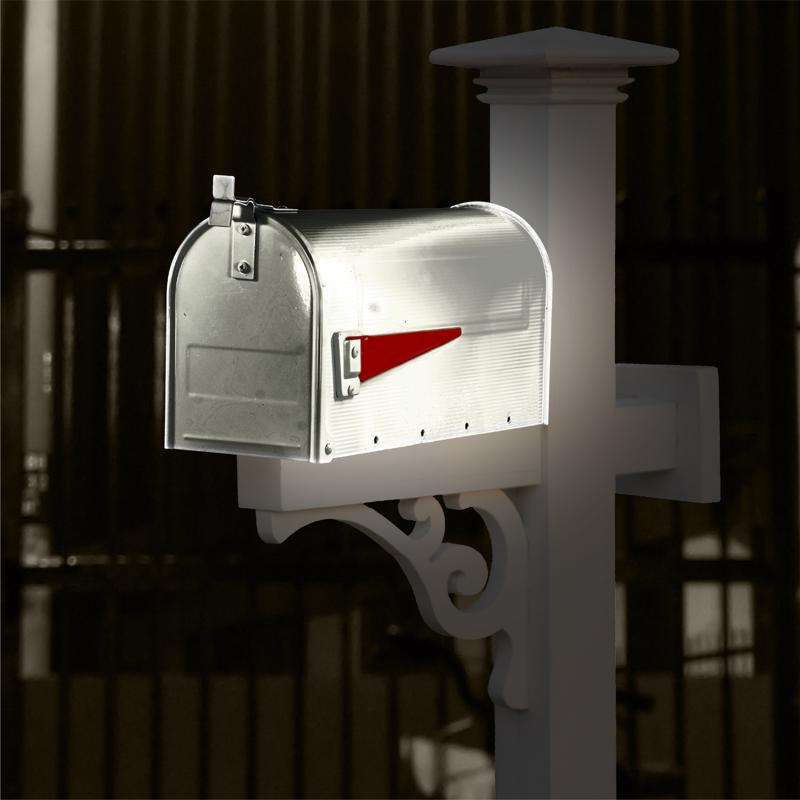 Metal mailbox painted with Rust-Oleum Reflective Finish Spray Paint on a decorative white post at night.