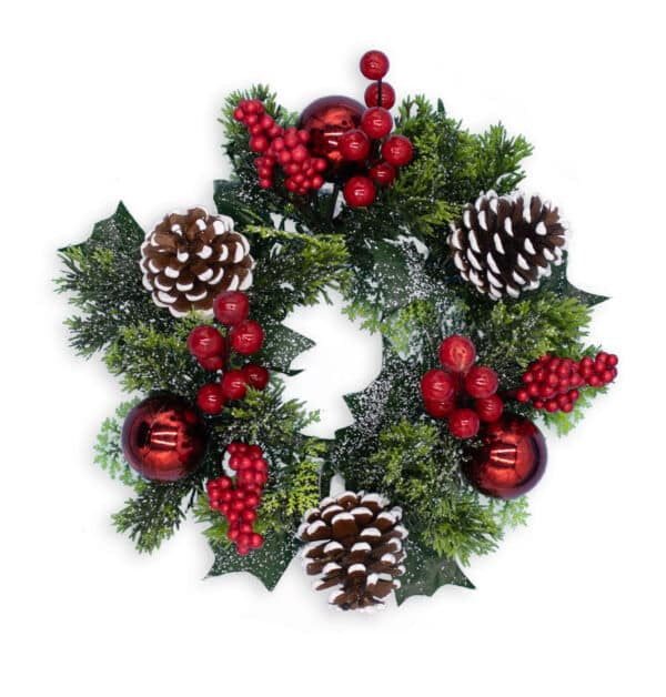 Christmas wreath with greenery, red berries, and pinecones on a white background