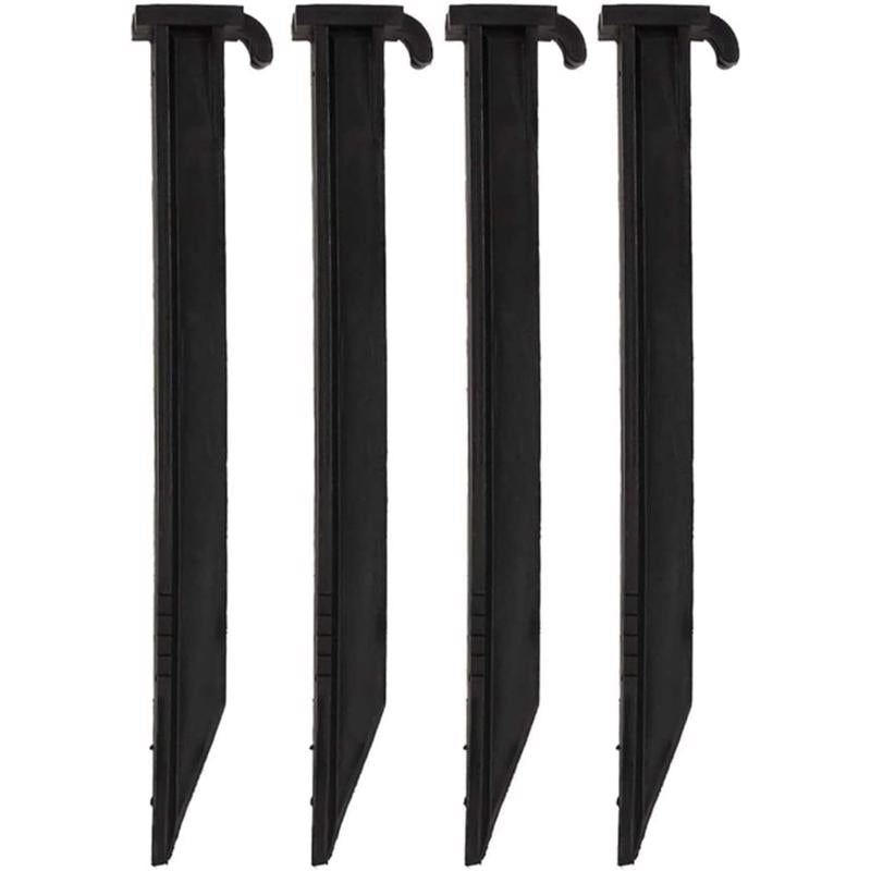 Four black tent stakes on a white background