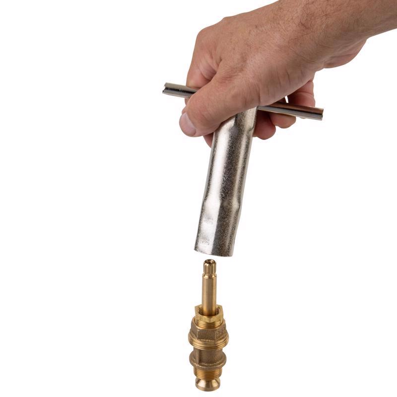 Hand holding a Superior Tool Shower Valve Socket Wrench with a brass fitting on a white background
