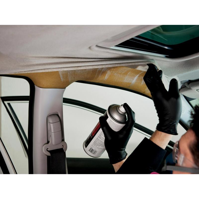 Person applying 3M Headliner Adhesive to a car's interior ceiling.
