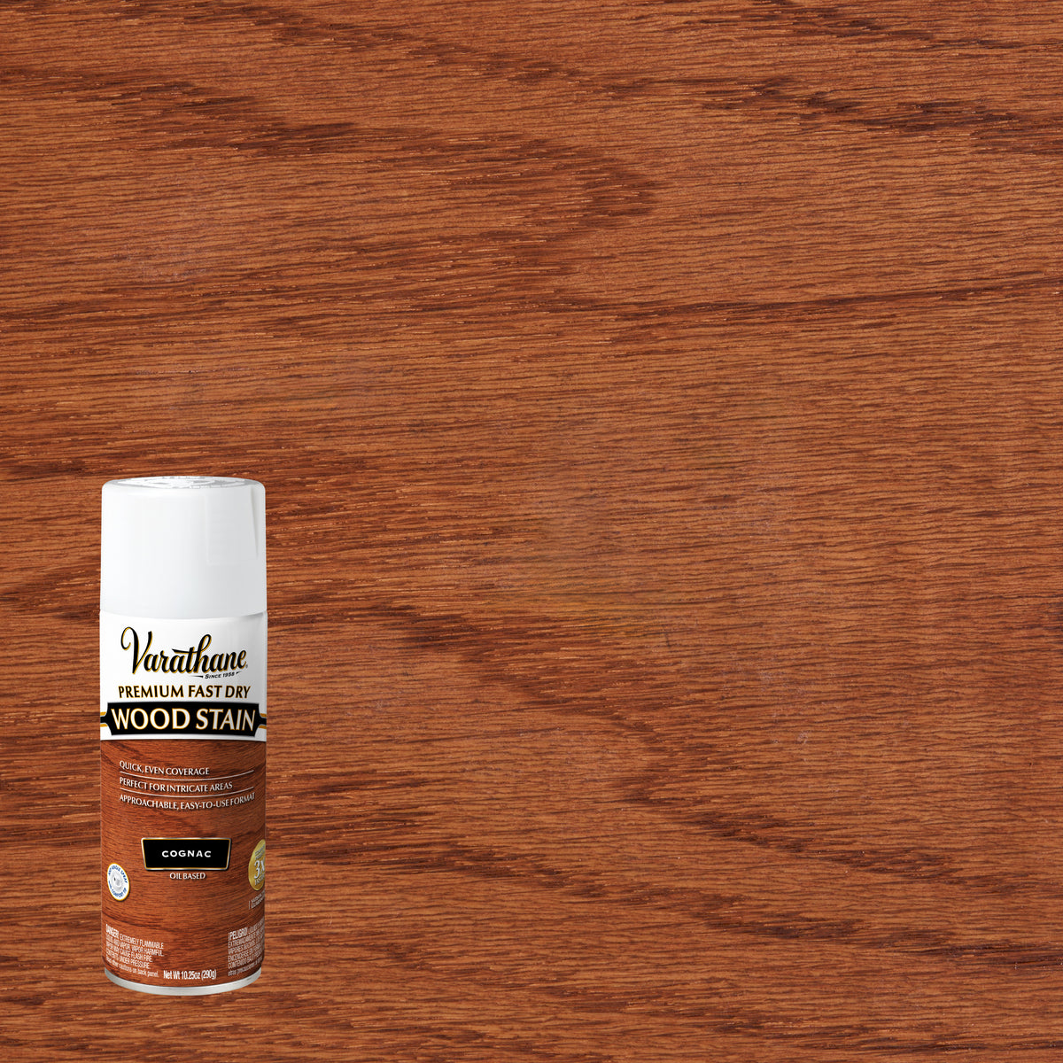 A can of Varathane Premium Fast Dry Wood Stain in the Cognac colorway, positioned in the lower-left corner against a large wood grain background showing the stained finish.