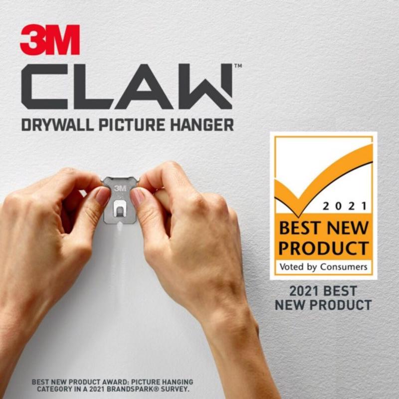 3M CLAW drywall picture hanger with hands demonstrating use on a gray wall, featuring a 'Best New Product' award badge.