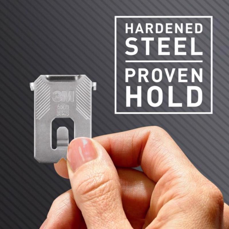 3M CLAW drywall picture hanger held by a hand with 'Hardened Steel Proven Hold' text on a dark background