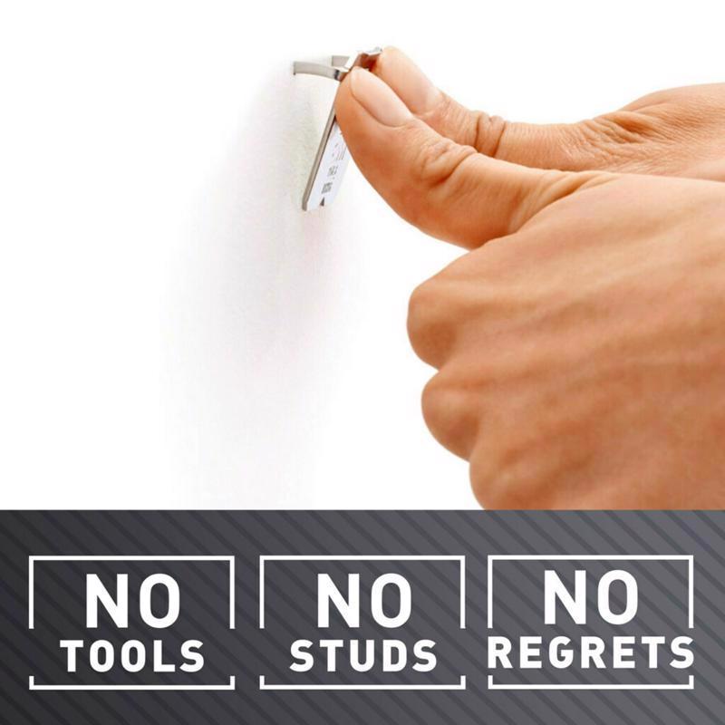Hand holding a small tool with text 'No Tools, No Studs, No Regrets' on a white background.