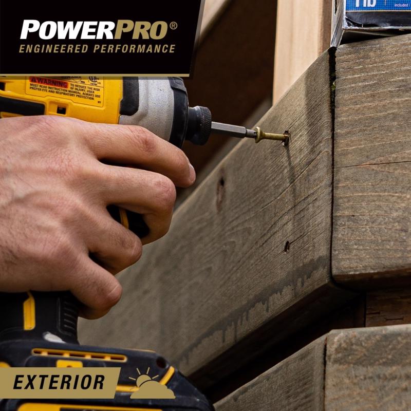 Person using a drill to screw a Hillman PowerPro screw into wooden exterior panels.