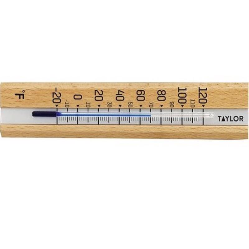 Wooden thermometer with metal scale on a white background, brand 'Taylor' visible