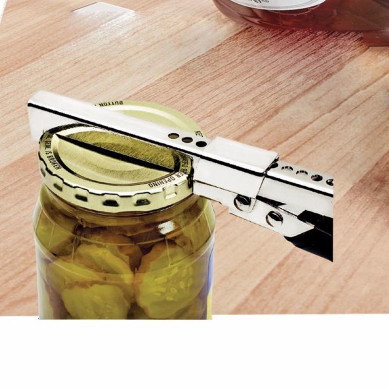 Jar lid being removed with a jar opener on a wooden surface