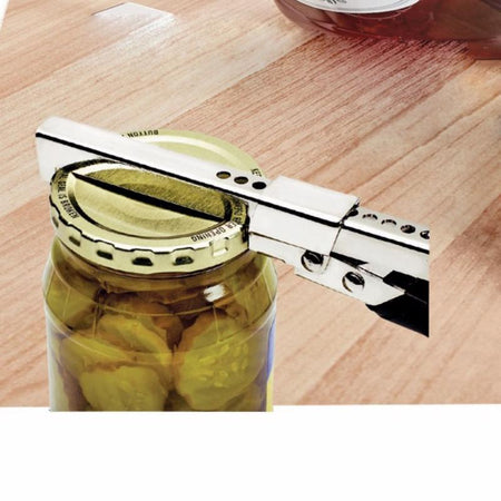 Jar lid being removed with a jar opener on a wooden surface