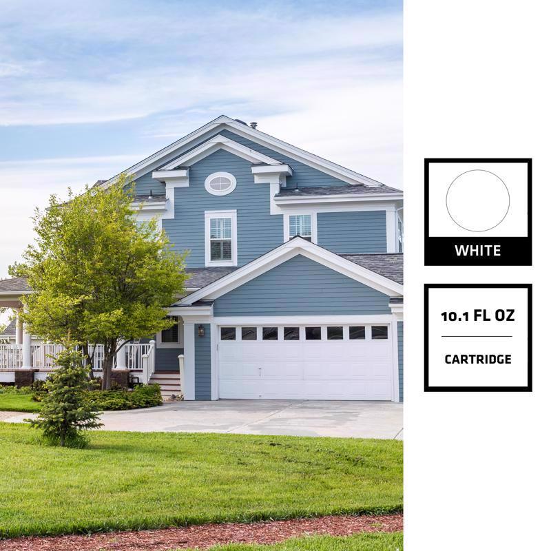 Blue house with white garage door on a clear day, with a white ink cartridge label overlay.