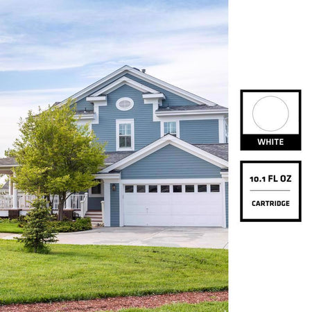 Blue house with white garage door on a clear day, with a white ink cartridge label overlay.