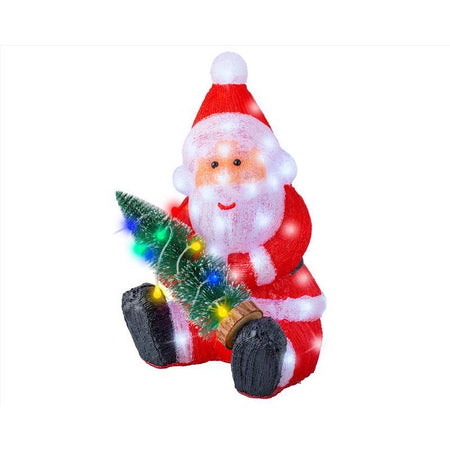 Decorative figure of Santa Claus holding a small Christmas tree with lights on a white background