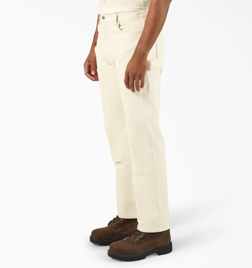 Front view of person wearing Dickies Natural Double Knee Relaxed Fit Painter's Pants and brown boots on a white background