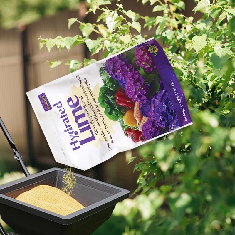 Bonide Hydrated Lime being poured into a spreader