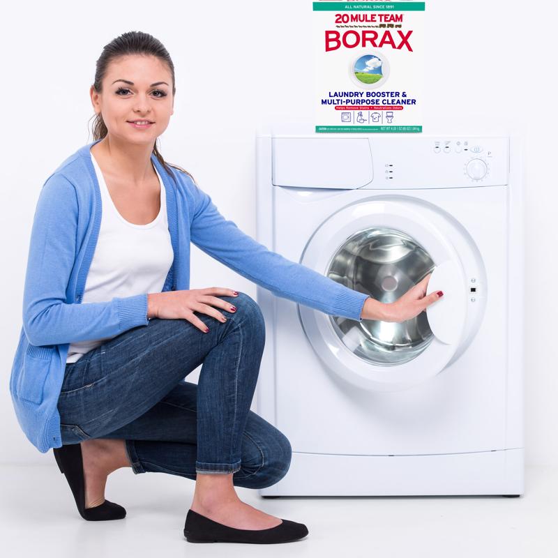 Woman using 20 Mule Team Borax Detergent Booster for laundry
