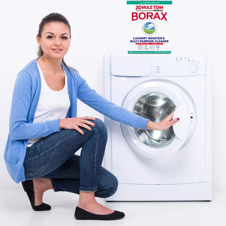 Woman using 20 Mule Team Borax Detergent Booster for laundry