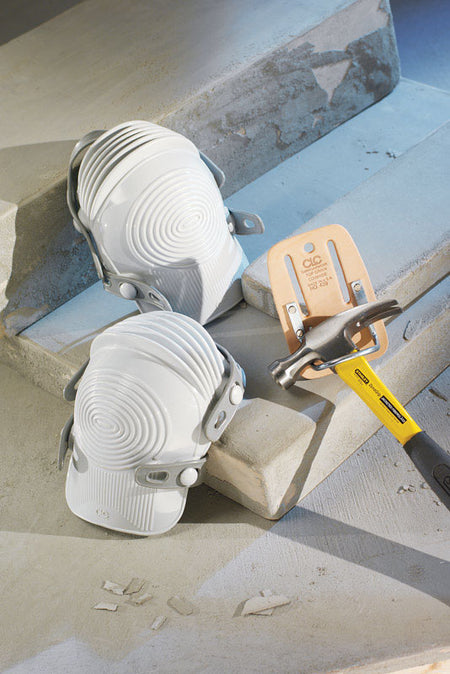 CLC Ultra Flex Knee Pads 361 and a yellow tool on a concrete surface
