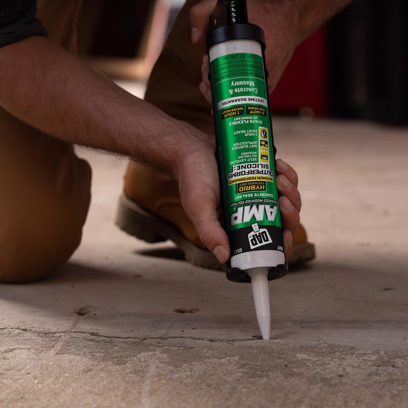 DAP 00764 9oz Gray AMP Concrete Sealant being applied to a crack in concrete.