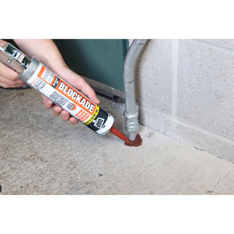 DAP 10.1 Oz Blockade High Performance Intumescent Acrylic Sealant being applied to pipe going into concrete.