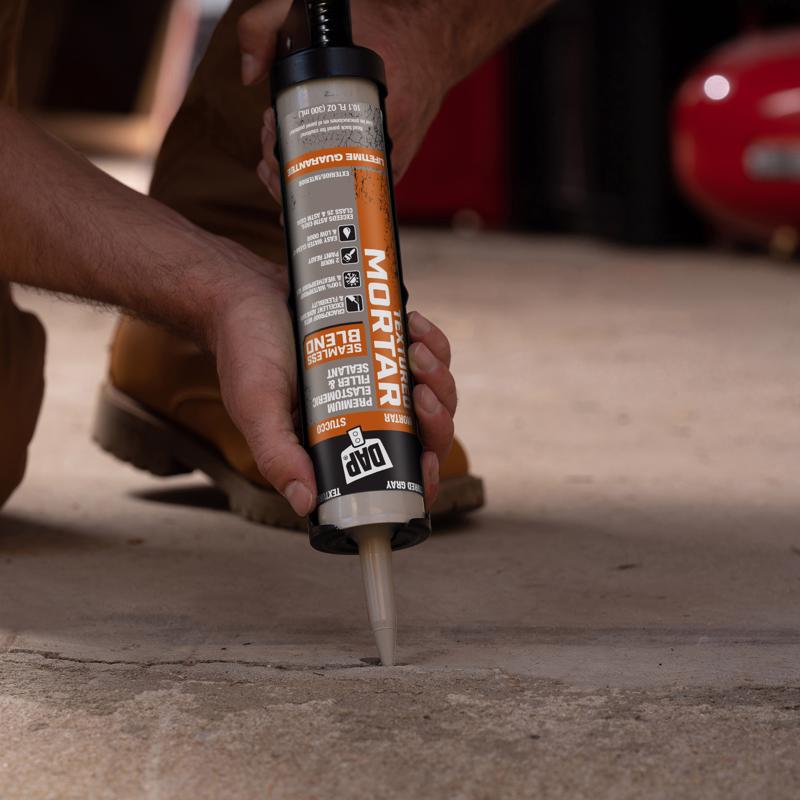 DAP Premium Textured Mortar Elastomeric Latex Filler & Sealer being applied to a crack on concrete slab.